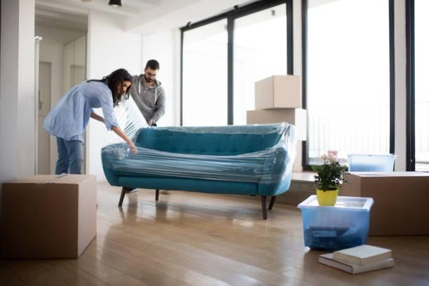 Couple moving sofa | A & S Carpet Collection